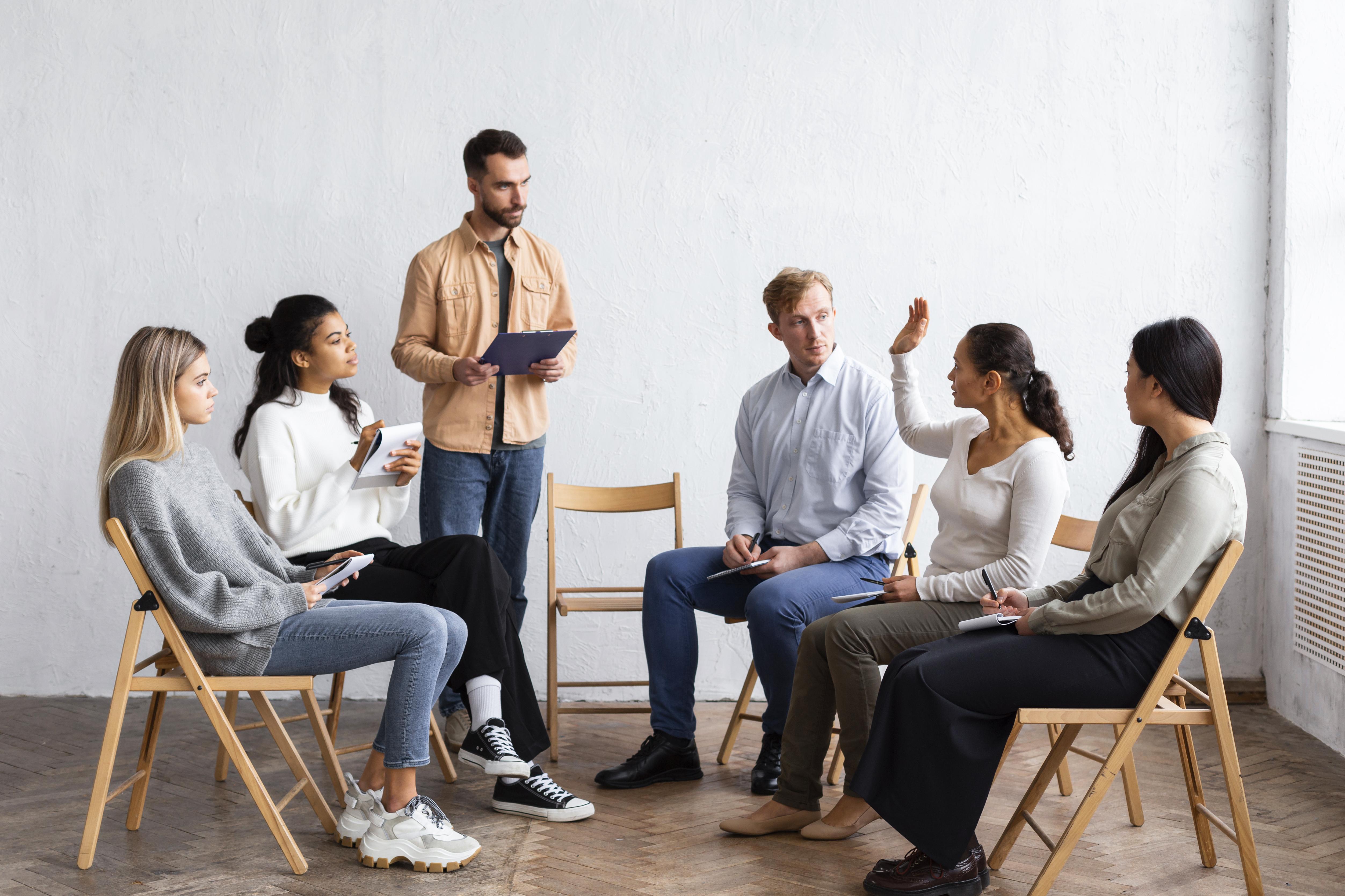 people-attending-group-therapy-session-while-sitting-chairs